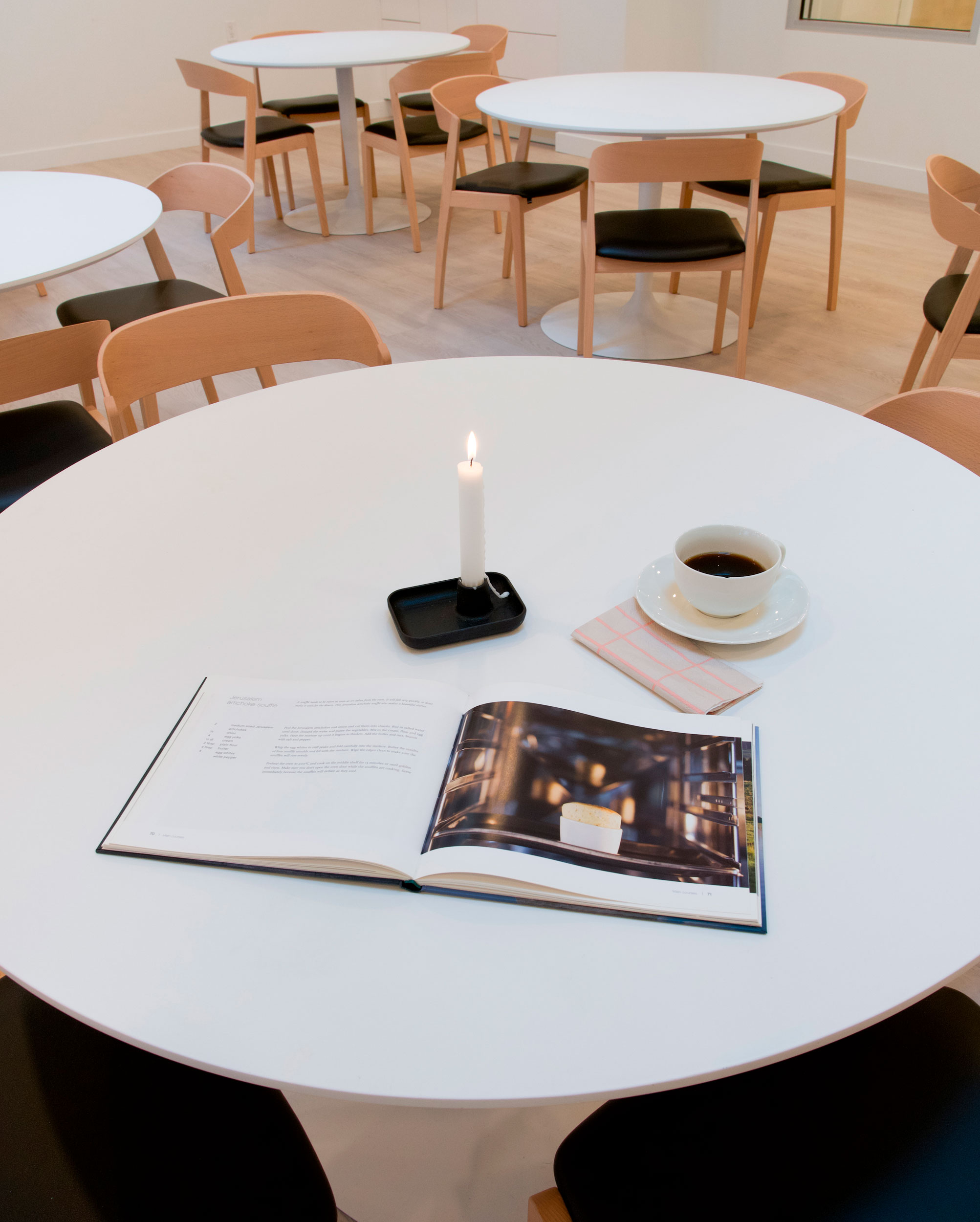 We selected sturdy, weighted pedestal tables to provide unobstructed seating and to allow a wheelchair to pull in easily. Round tables encourage social connection by allowing everyone to face one another naturally. White tabletops were chosen for their ability to reflect light — an important consideration as vision becomes more sensitive with age.