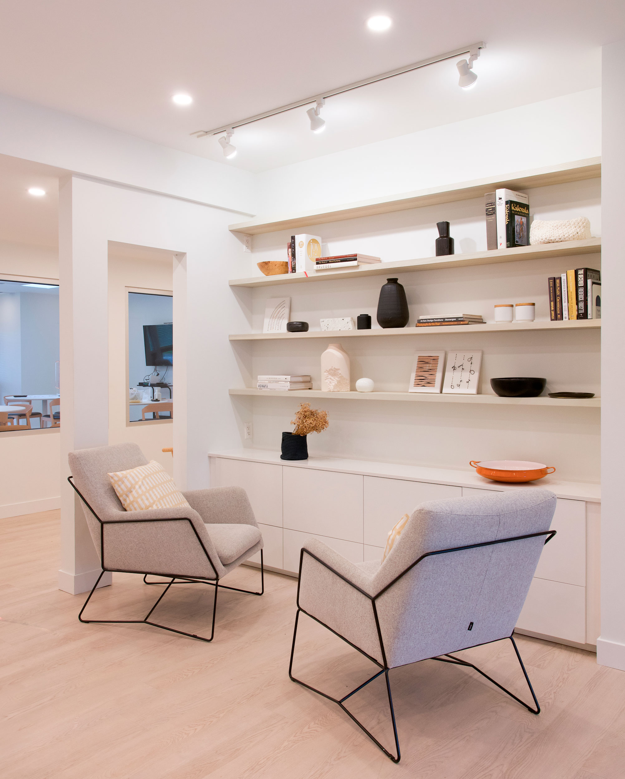 Custom ash shelving in the front lobby — a natural element designed to make the space feel more like home.