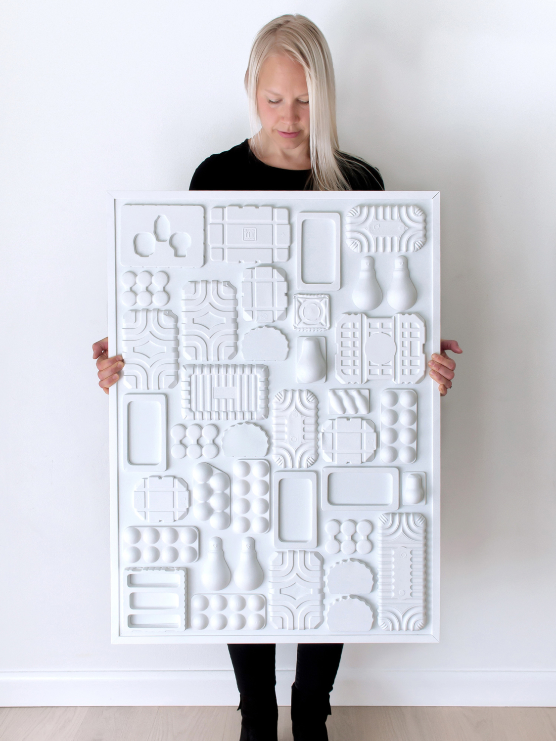 Salonen’s hand-cast, bas-relief sculptures, titled “Discarded,” question the narrative of disposable packaging as end-of-life waste.