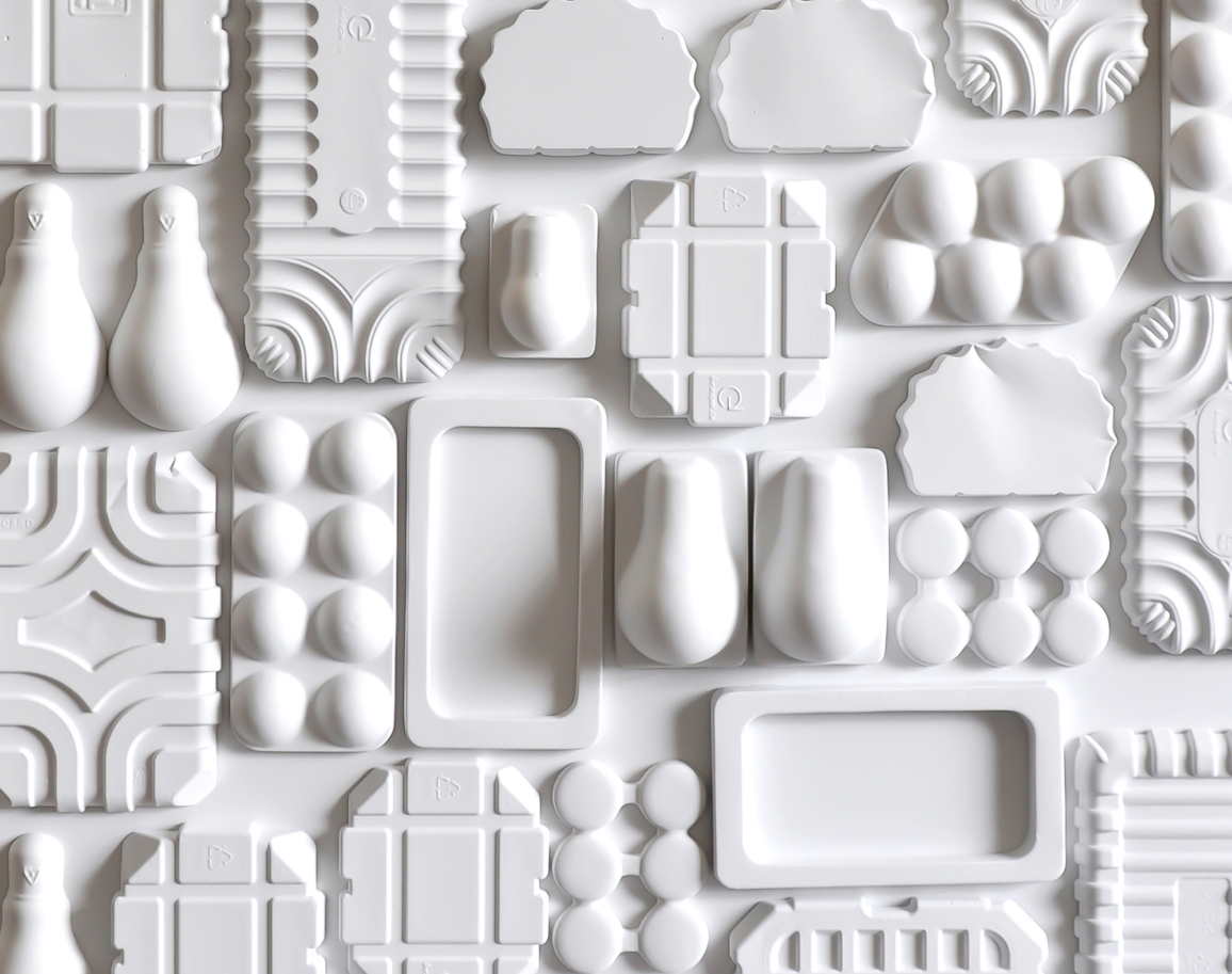 Discarded. Bas-relief sculpture comprised of plaster elements that are hand-cast from discarded plastic packaging.
